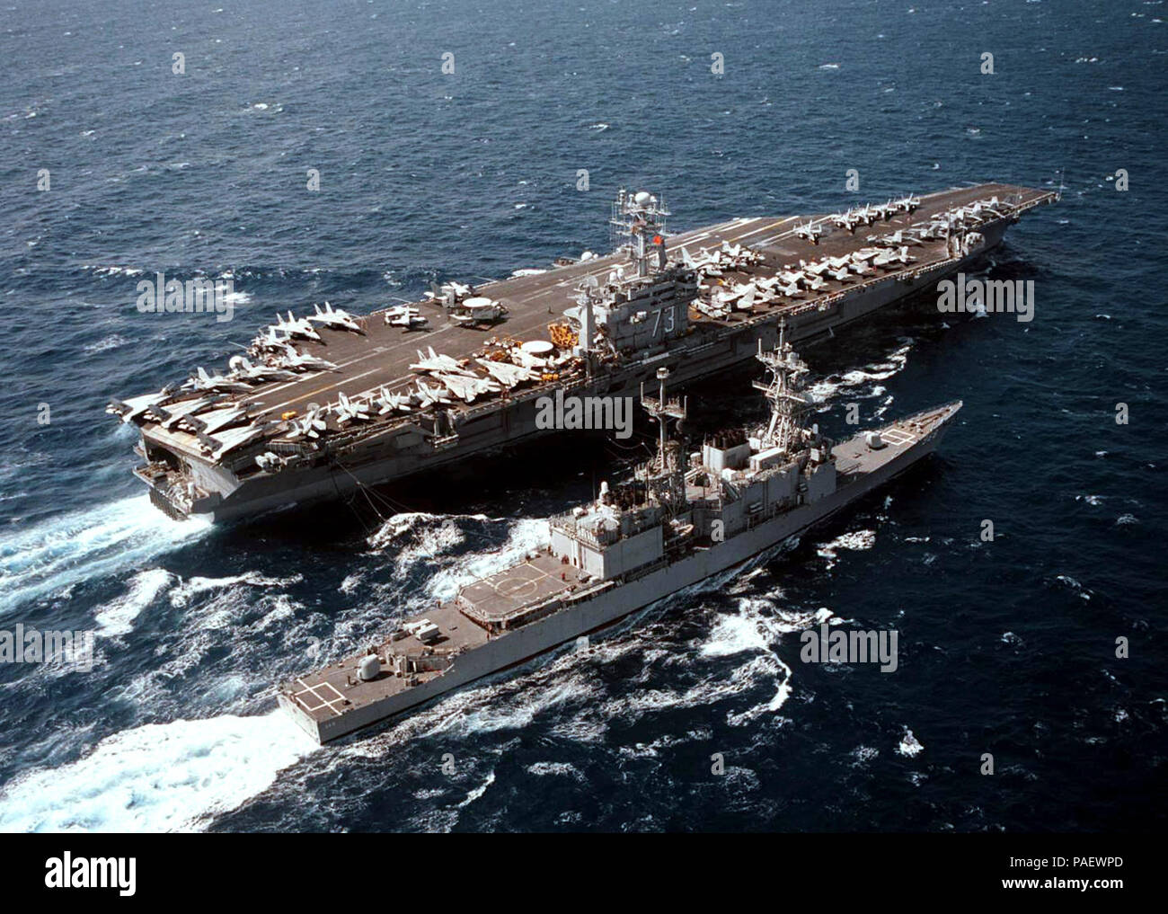 U.S. Navy's nuclear powered aircraft carrier USS George Washington (CVN 73) and guided missile destroyer USS Arthur W. Radford (DDG 968) conduct replenishment at sea operations in the western Mediterranean Sea, July 11, 1996.  Both vessels are nearing the completion of a scheduled six-month deployment. George Washington's battle group has sustained operations in support of the NATO-led peace keeping efforts in Bosnia under Operation Decisive Endeavor in the Adriatic Sea, and UN sponsored sanctions against Iraq, under Operation Southern Watch in the Arabian Gulf.  U.S. Navy Stock Photo