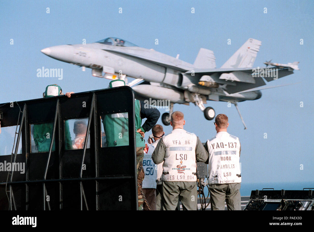 Gulf (December 23rd, 1997) On board the nuclear powered aircraft carrier USS George Washington (CVN 73). . . .A F/A-18C ТHornetУ from Fighter Attack Squadron Eighty Two (VFA-82) is guided to the flight deck by a team of Landing Signals OfficerХs. George Washington and Carrier Air Wing One (CVW 1) are currently conducting operations in the Persian Gulf in support of UN sanctions against Iraq under operation Southern Watch.  U.S. Navy Stock Photo