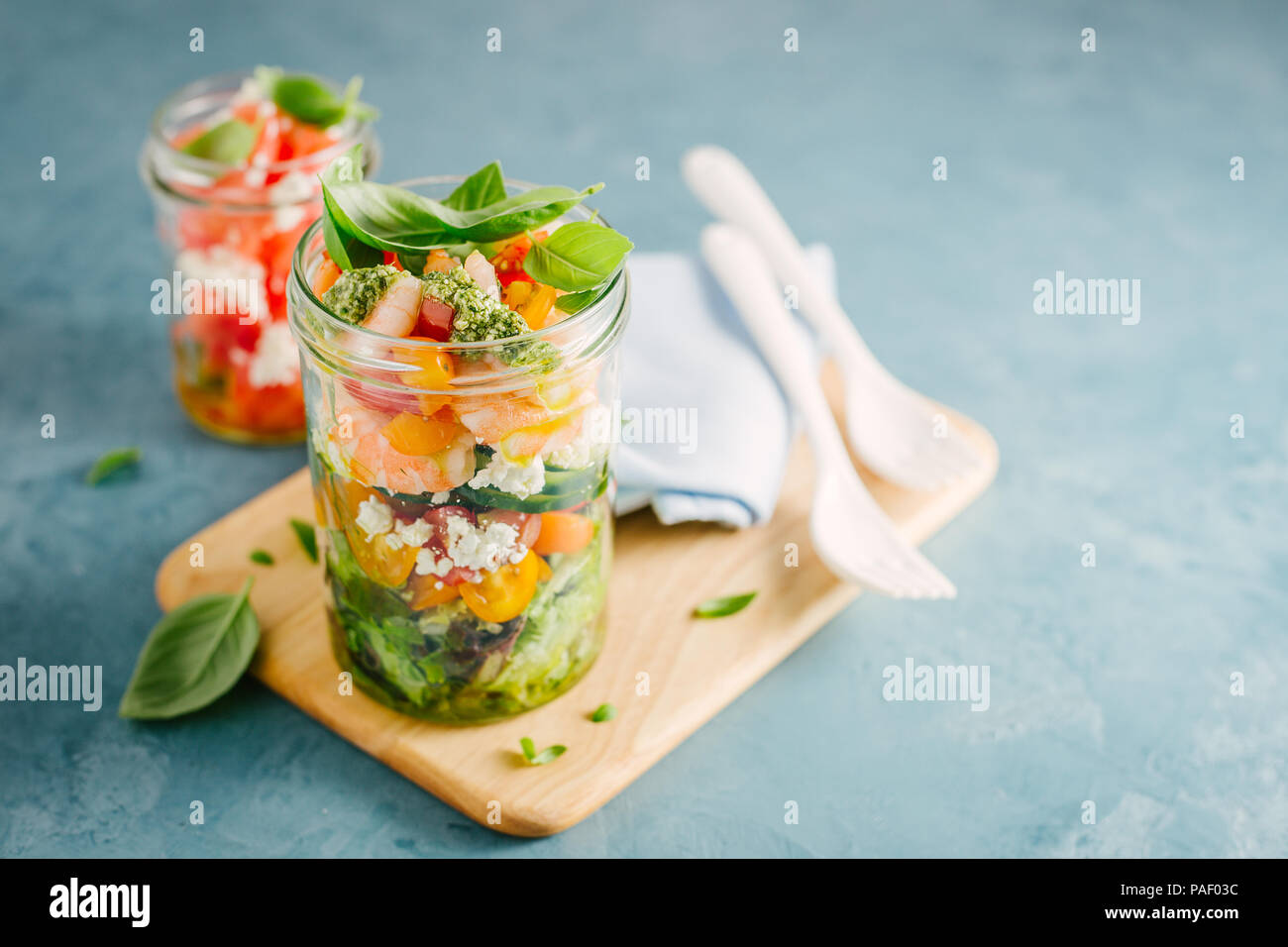 Tasty served salad wuth prawns in jar on table. Ready to eat. Detox Clean Eating Concept Stock Photo