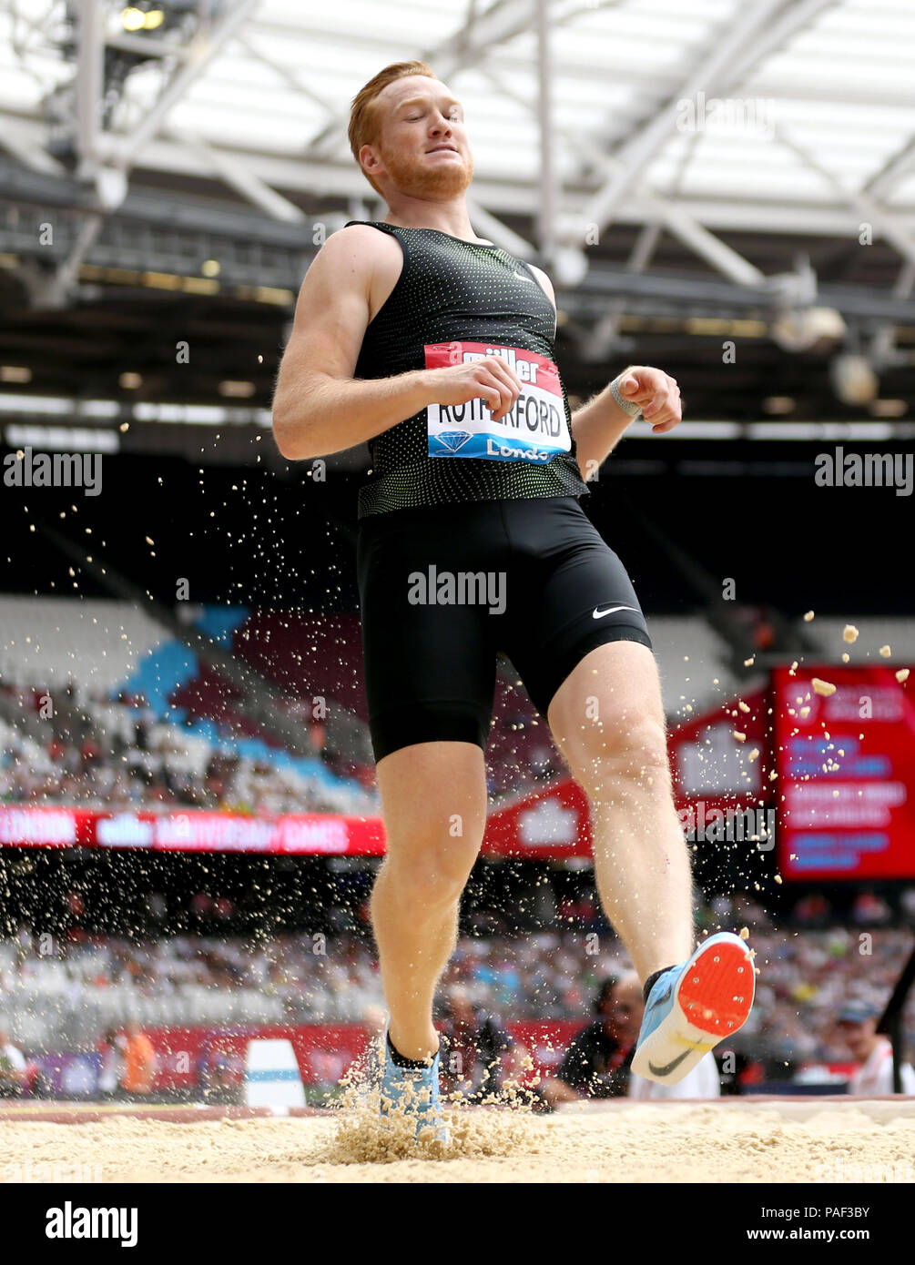 Great Britain's Greg Rutherford fails his first attempt at clearing a jump in the Men's Long Jump during day two of the Muller Anniversary Games at The Queen Elizabeth Stadium, London. Stock Photo