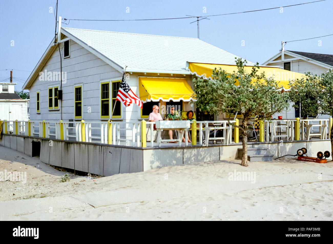 People relaxing on a bungalow porch at Breezy Point, Long Island