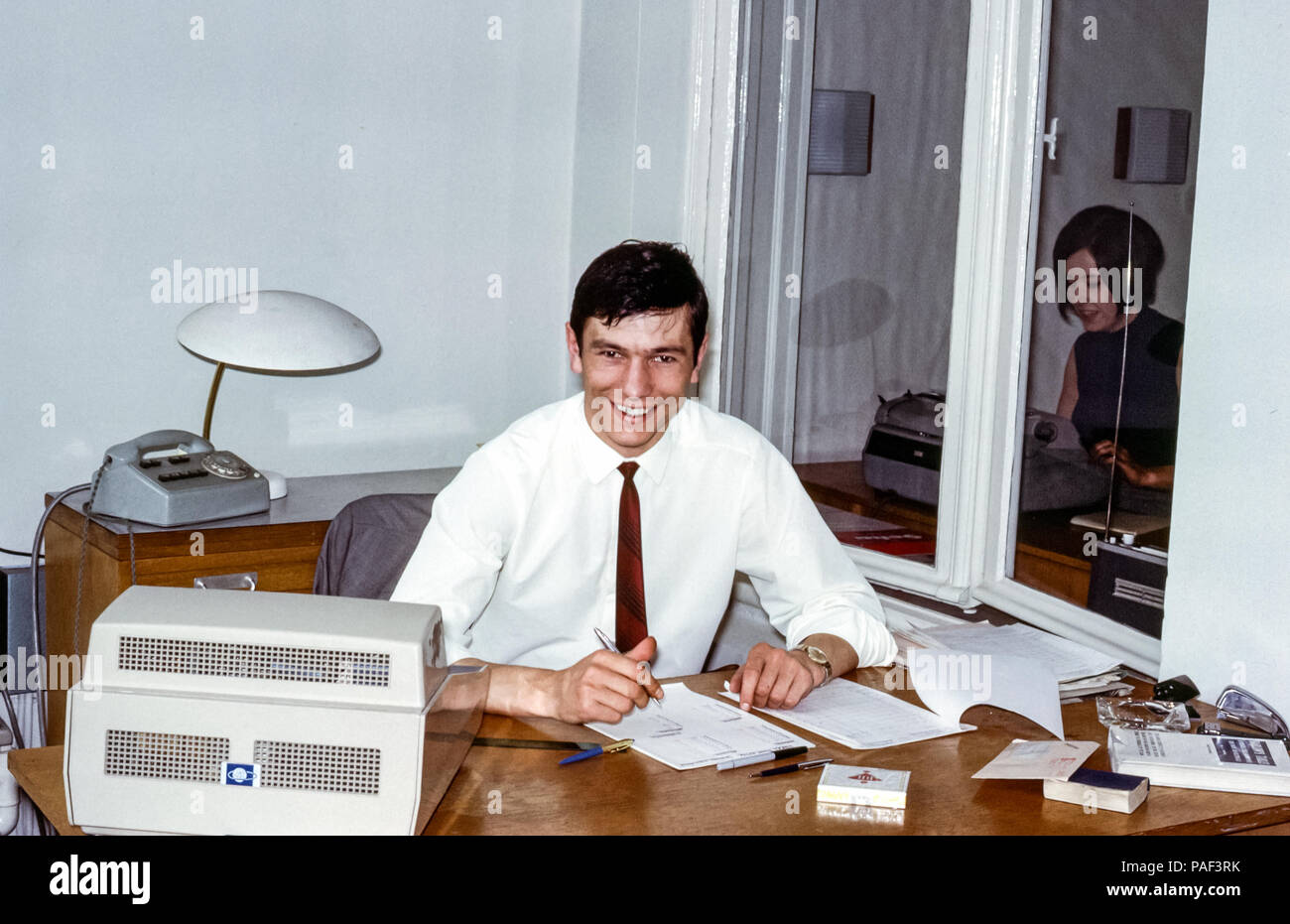 A Male Employee At A Desk With Old Fashioned Office Equipment In