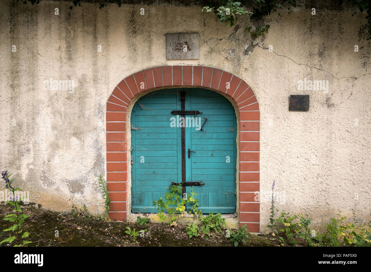 Entrance of a traditional wine cellar in Lower Austria, door and ventilation hole, initials of