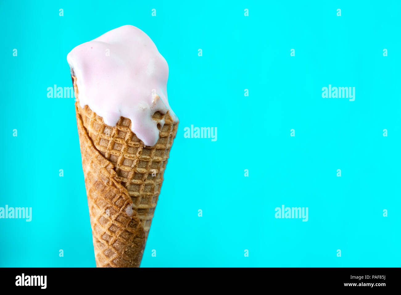 melted ice cream cone on mint blue background Stock Photo Alamy