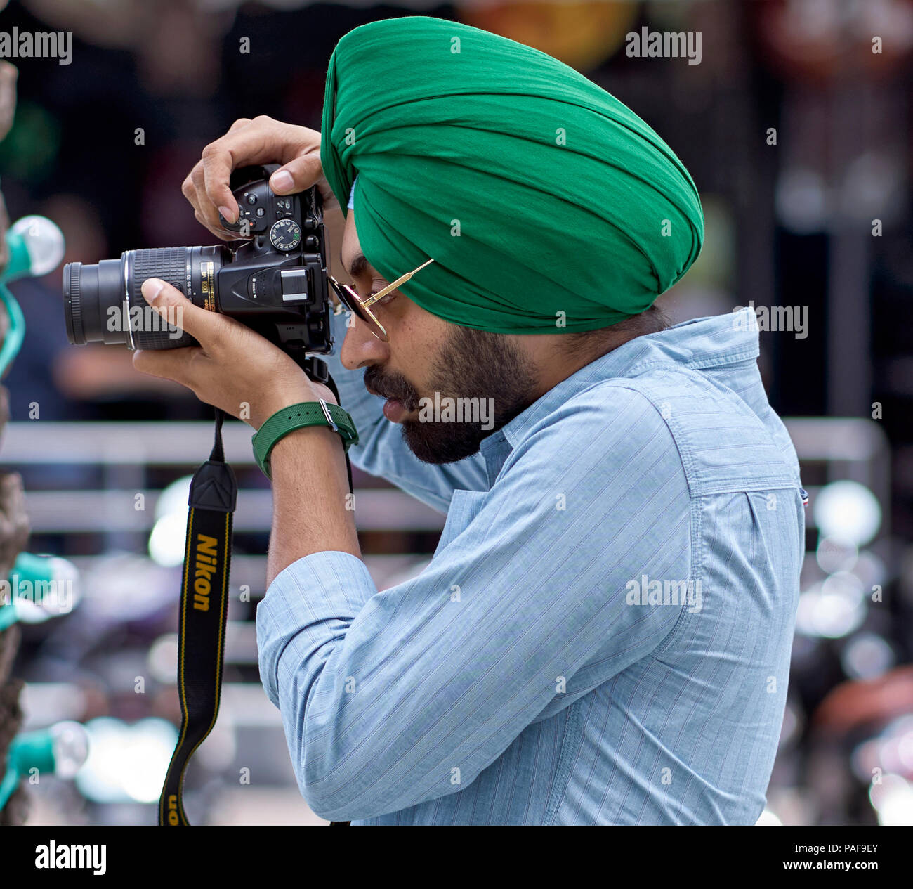 Indian Sikh man taking a photograph Stock Photo
