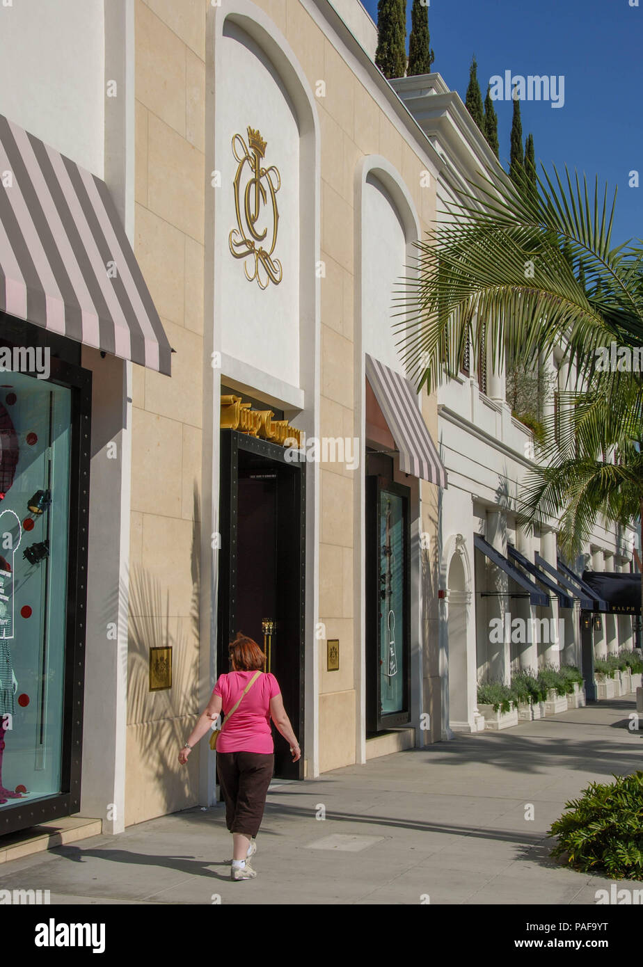 Person walking along the row of designer shops in Rodeo Drive, Beverly Hills, Los Angeles Stock Photo