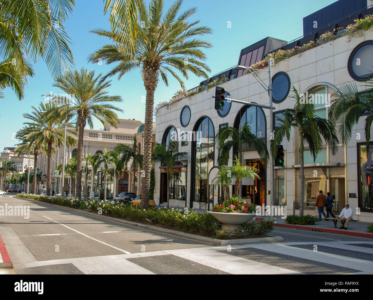 Wide angle view of designer shops and palm trees on Rodeo Drive, Beverly Hills, Los Angeles Stock Photo
