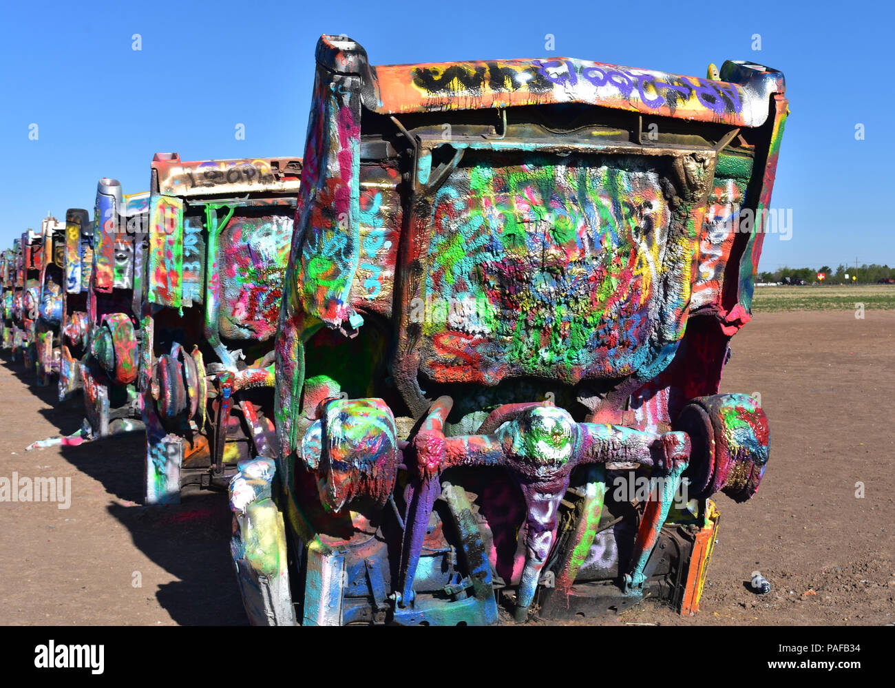 Very colorfully spray painted old cadillacs at Cadillac Ranch Stock