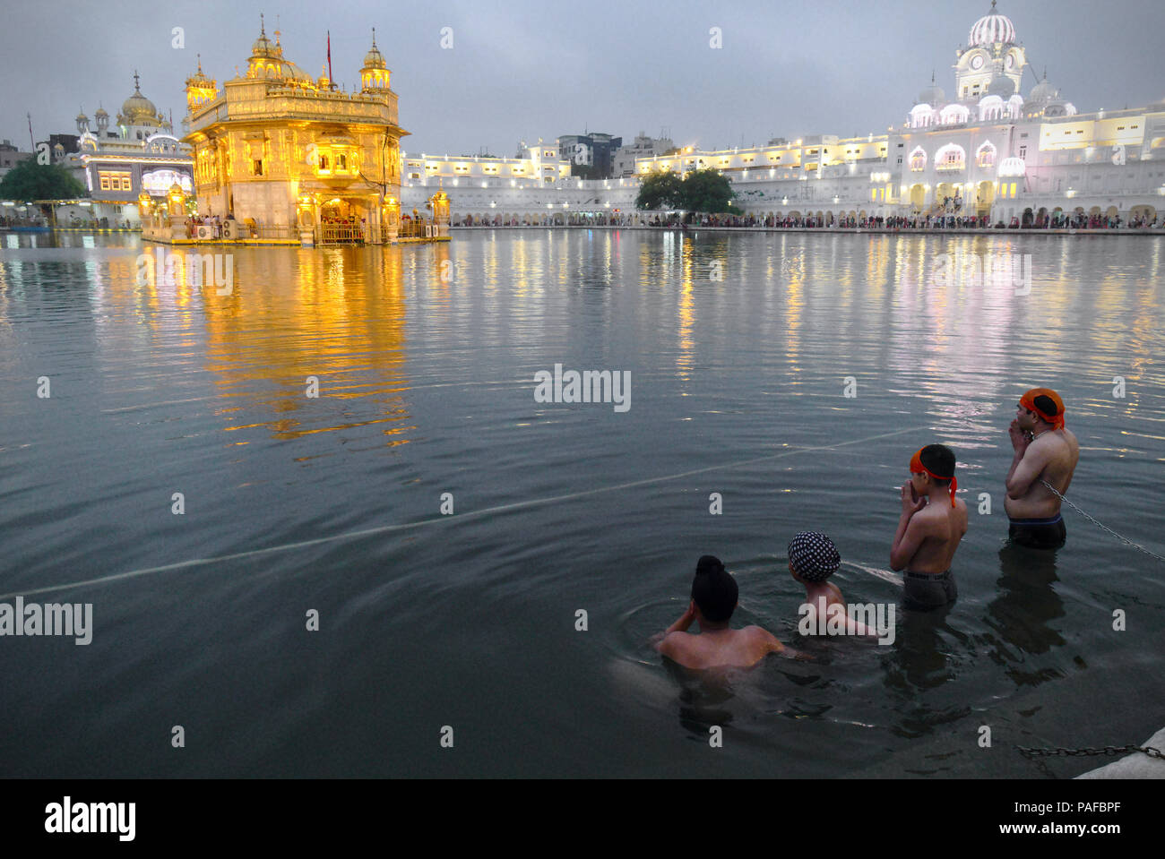 Pilgrims bathing at the sarovar (sacred pool) of Golden Temple Stock ...