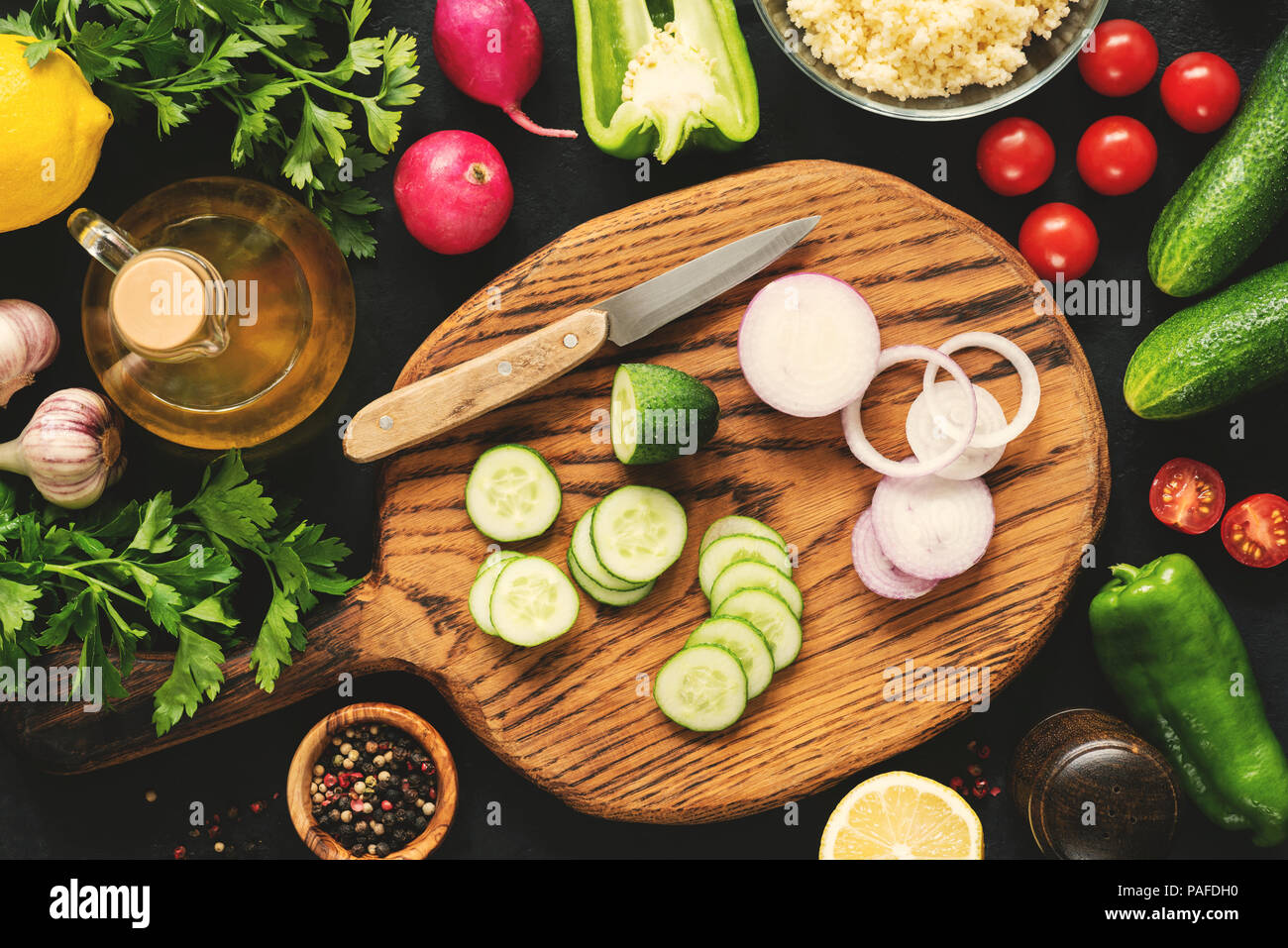 Cutting vegetables for healthy salad. Top view cooking process, vegan