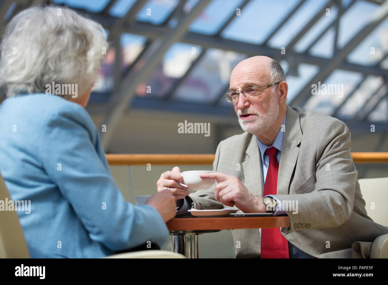 Senior people talking in cafe drinking coffee Stock Photo