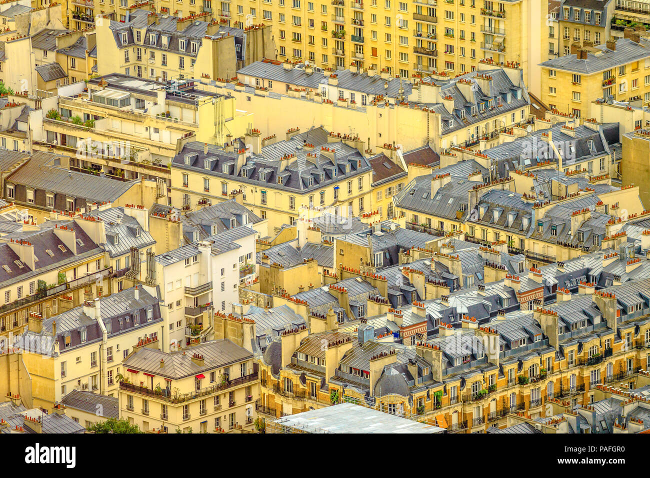 Aerial view of Parisian roofs downtown skyline from the panoramic overlook from Tour Montparnasse. Paris urban skyline and cityscape at sunset. Parisian style architecture details. France in Europe. Stock Photo