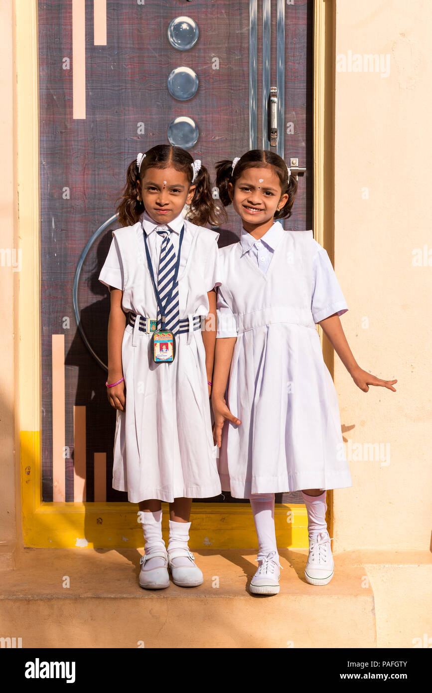PUTTAPARTHI, ANDHRA PRADESH, INDIA - JULY 9, 2017: Two little Indian girl in a school uniform. Vertical. Copy space for text Stock Photo