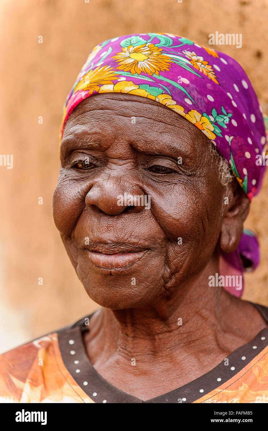 ACCRA, GHANA - MARCH 6, 2012: Unidentified Ghanaian old lady smiles in the street in Ghana. People of Ghana suffer of poverty due to the unstable econ Stock Photo