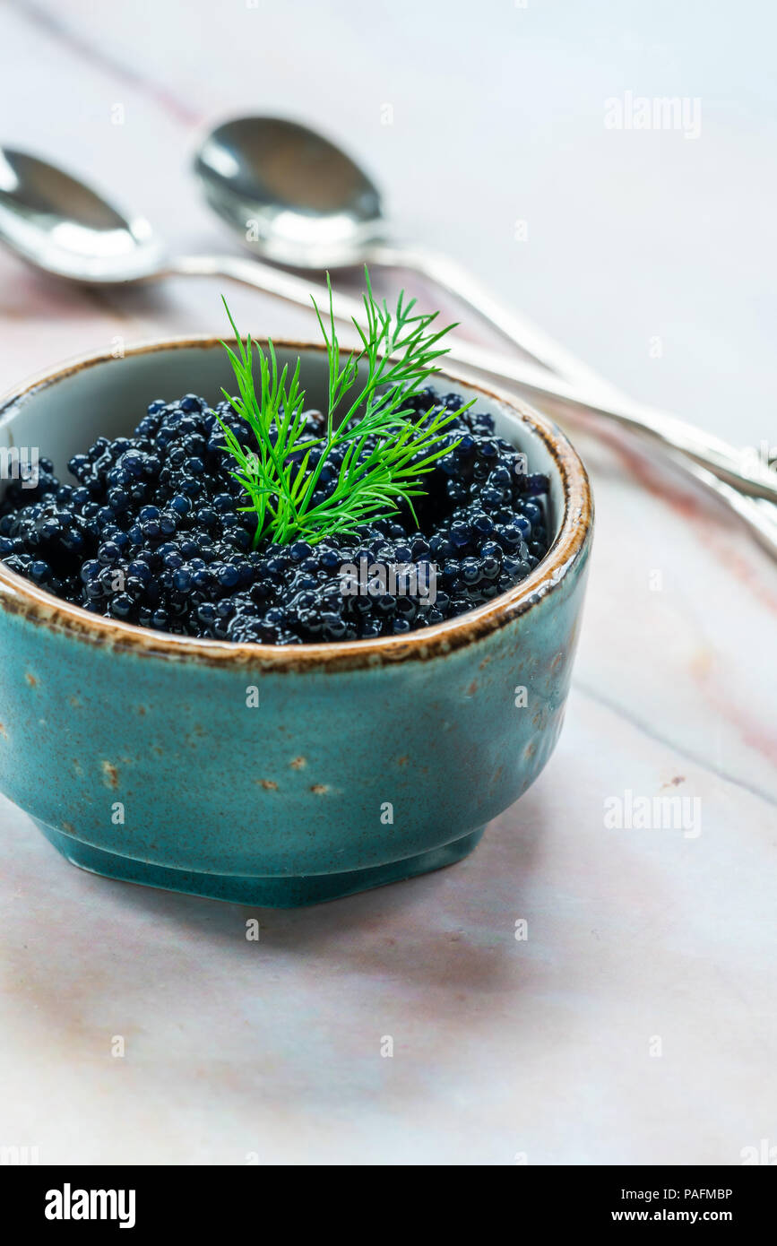 Black lumpfish caviar in a small pot Stock Photo