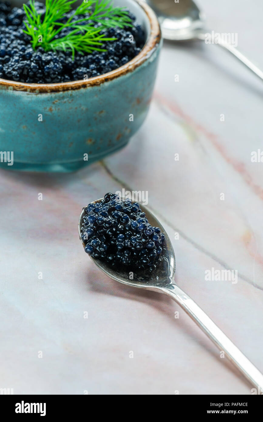 Black lumpfish caviar in a spoon Stock Photo
