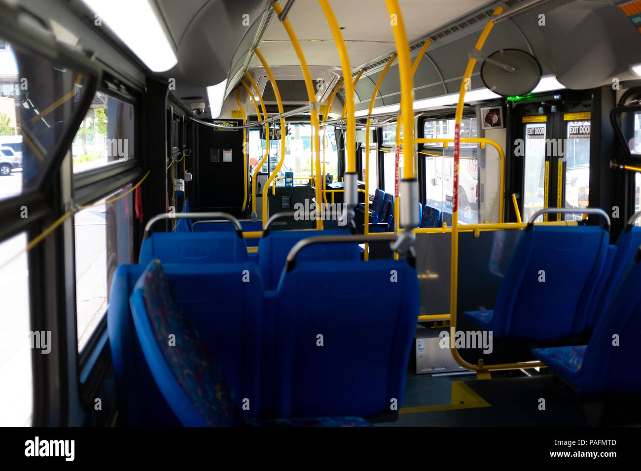 Horizontal colour image showing the interior of city bus with no people in it. Stock Photo