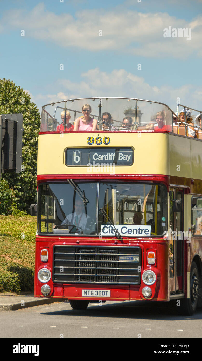 Head on view of an open top bus in Cardiff bay with visitors sitting on the top deck Stock Photo