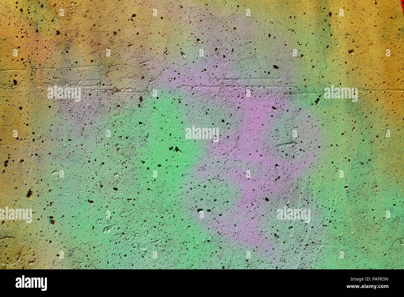 Concrete wall with spray paint graffiti suitable for background