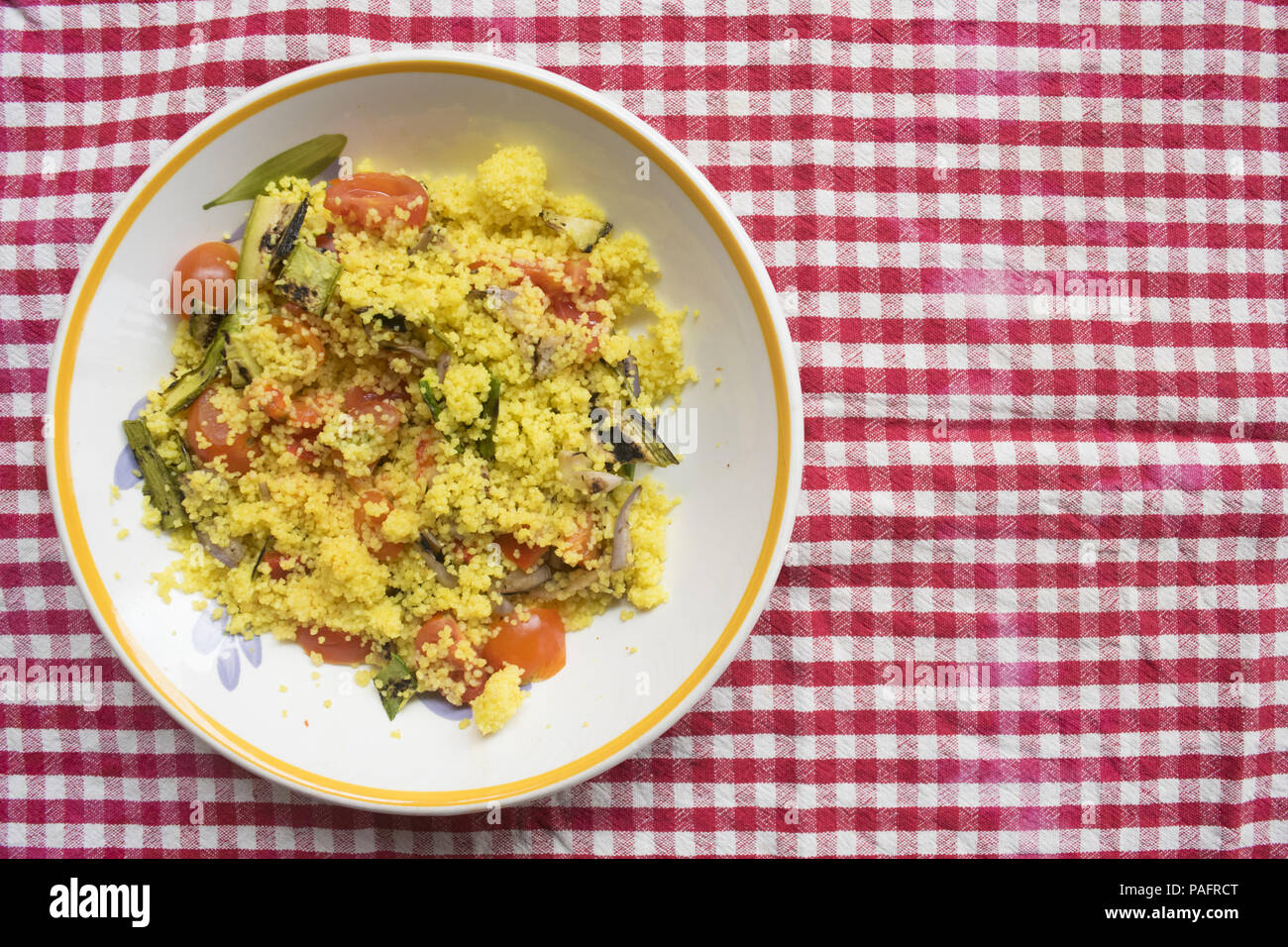 salad of cous cous with variety of roasted and raw vegetable Stock Photo