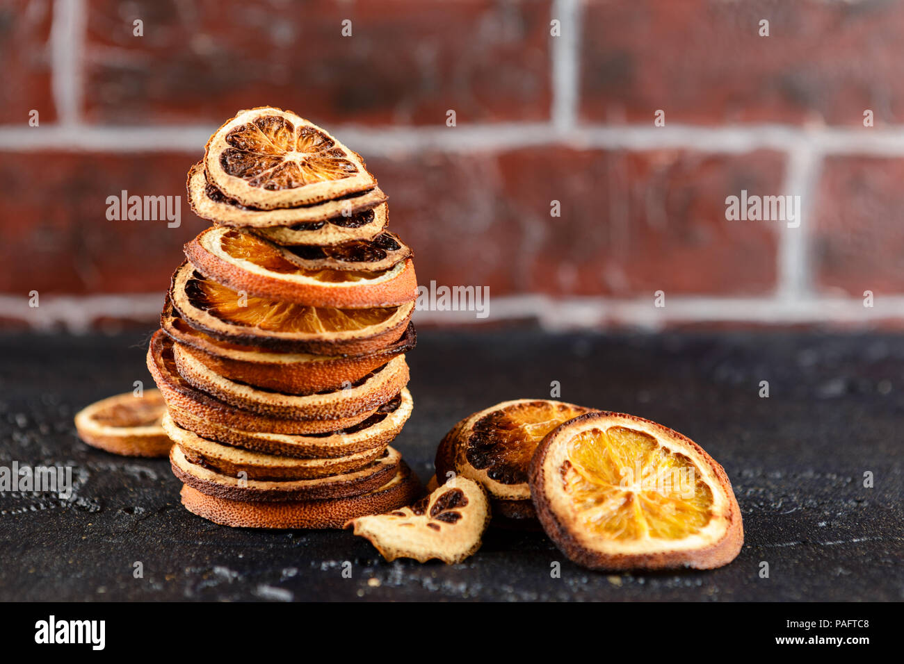 stack of dried orange slices on a black background Stock Photo - Alamy
