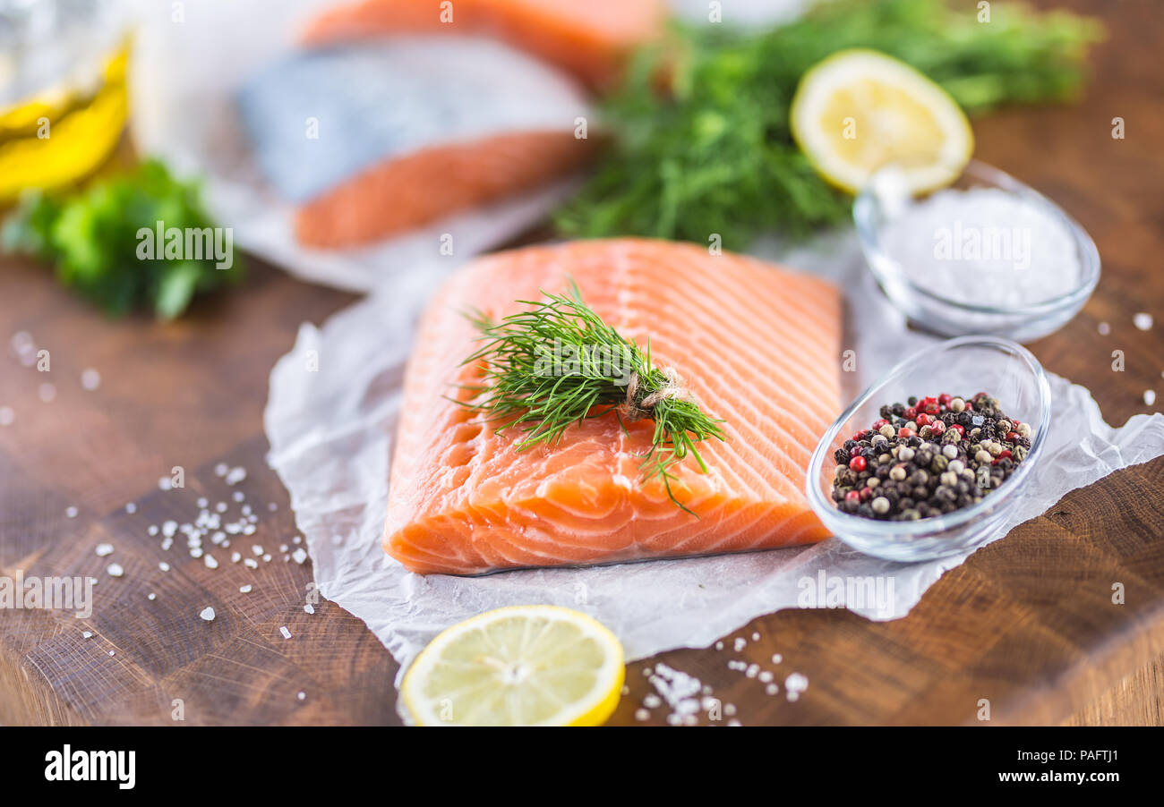 Raw salmon fillet with dill lemon olive oil salt and pepper Stock Photo