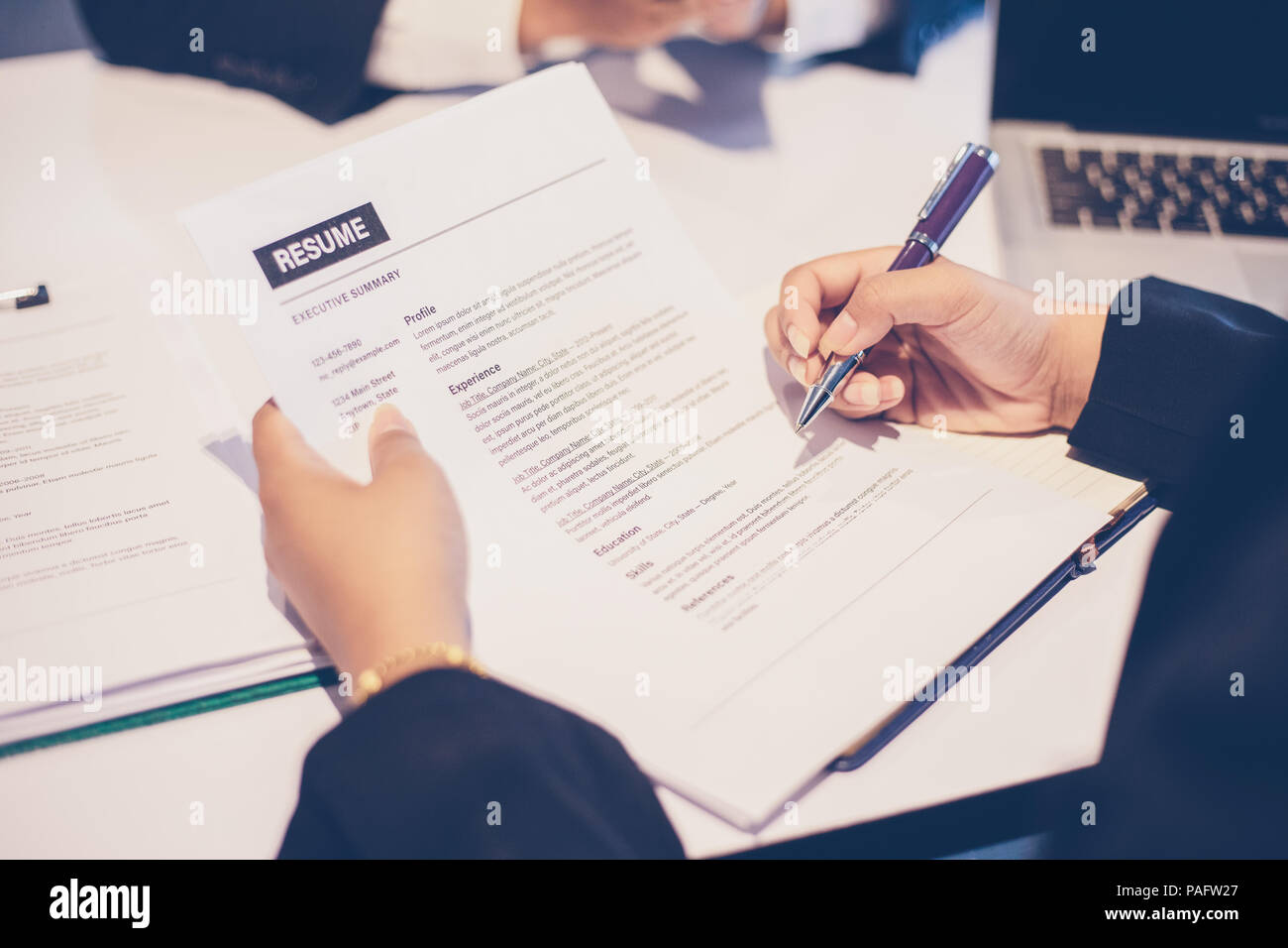 Businessmen and Businesswomen discussing documents for job interview concept Stock Photo