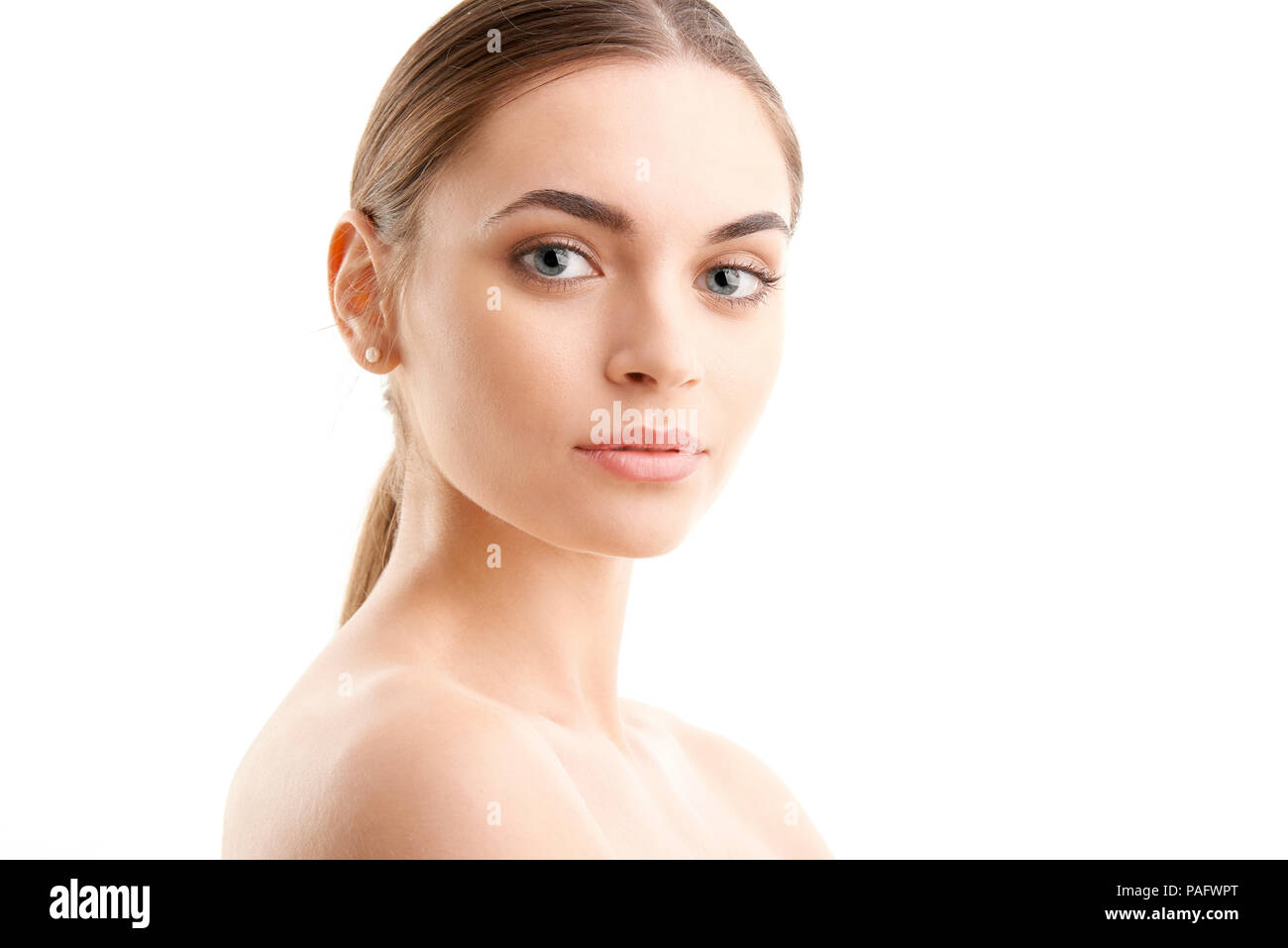Portrait of a beautiful young woman looking at camera and posing at ...