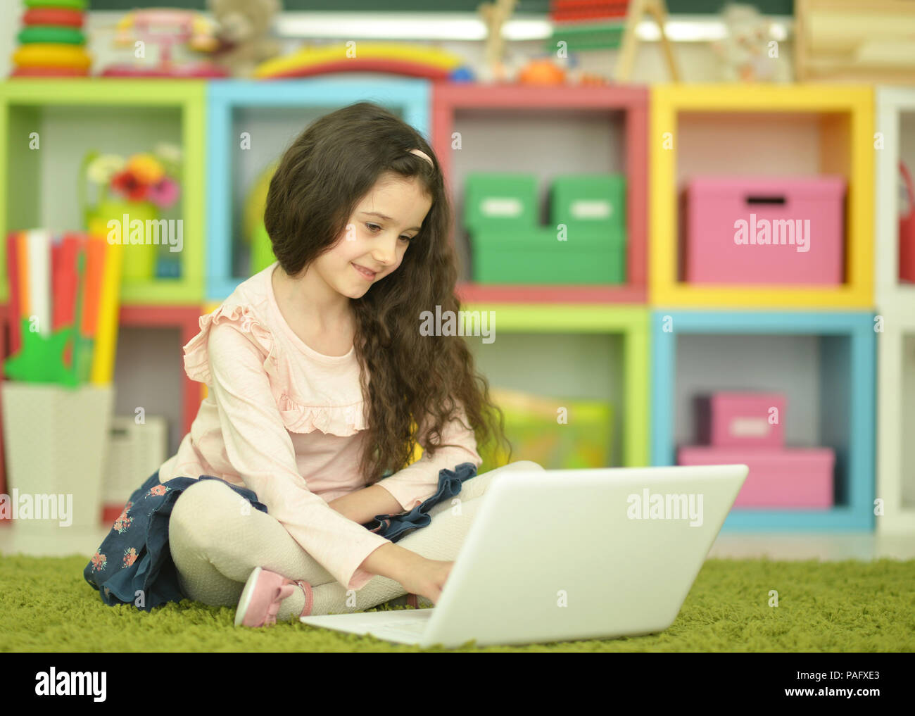 Emotional cute girl using laptop Stock Photo - Alamy