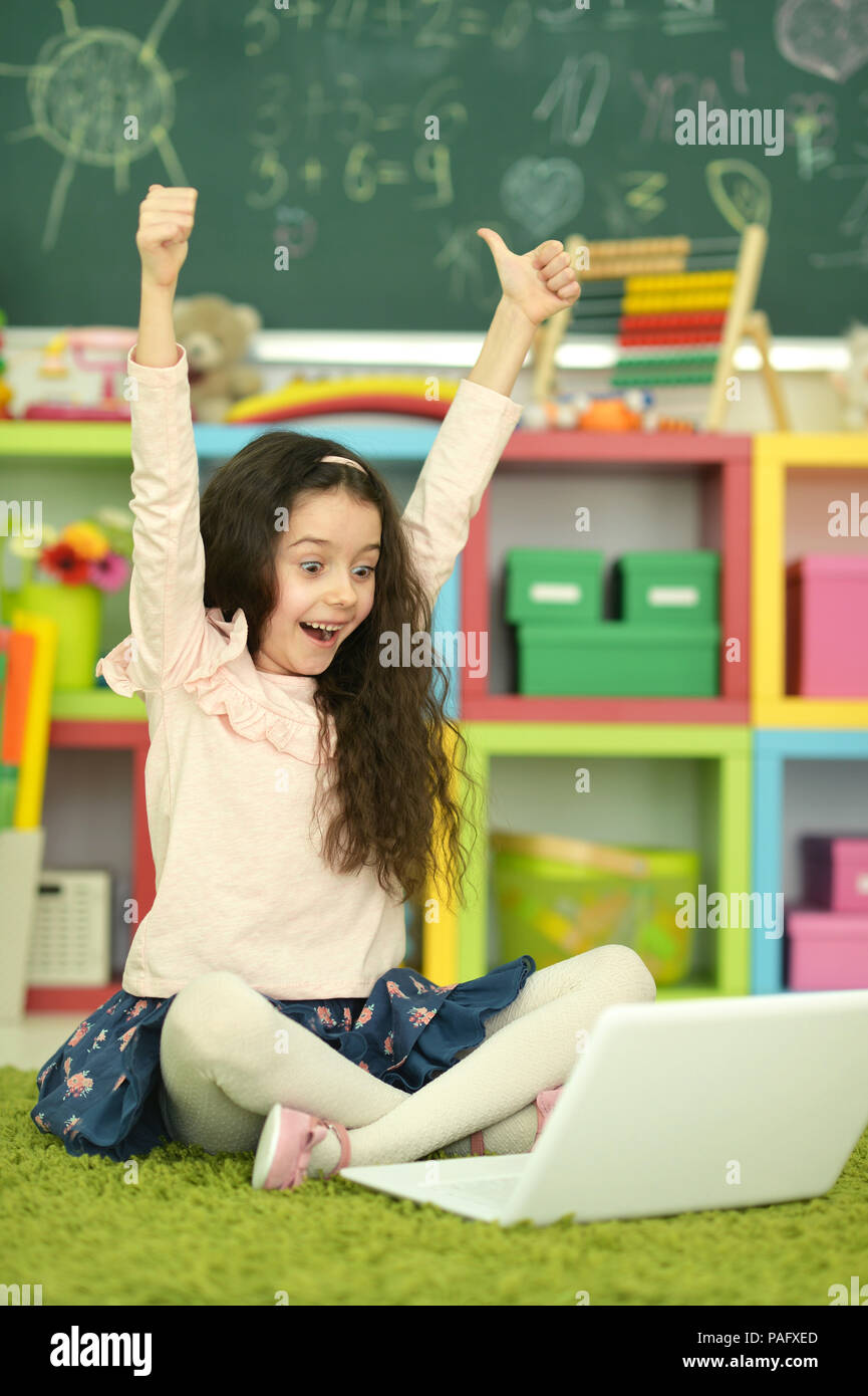 Emotional cute girl using laptop Stock Photo - Alamy