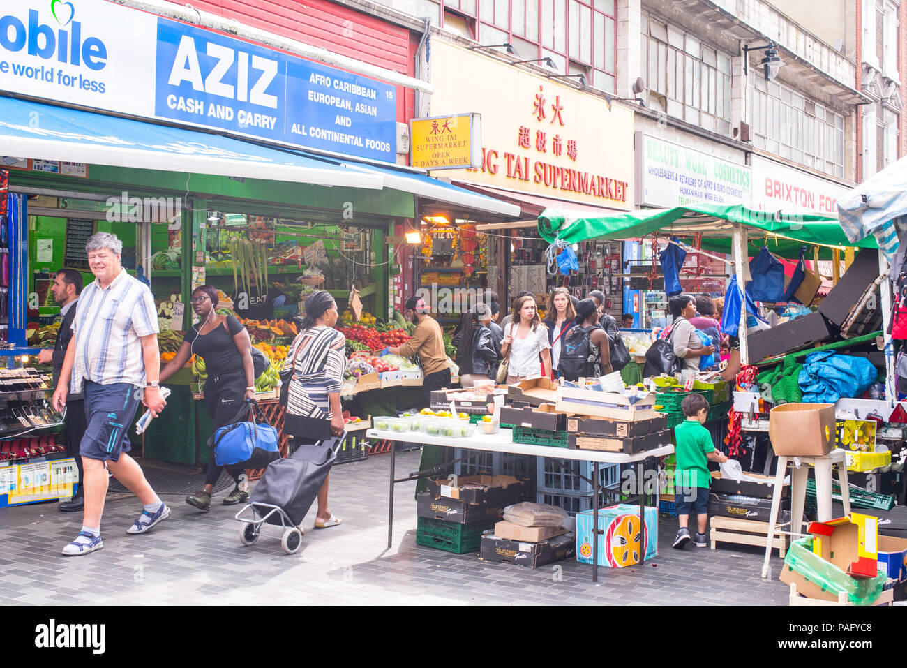 People shopping in Electric Avenue, Brixton, London. Built in the 1880s