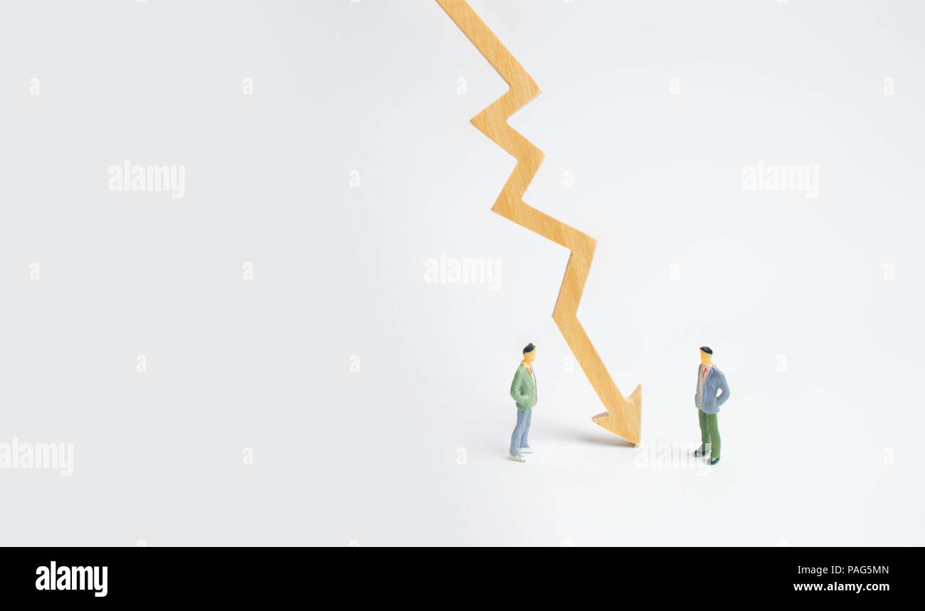 A wooden chart arrow down divides the two people discussing the case. Termination and breakdown of relations, breaking ties. Contract break, conflict  Stock Photo