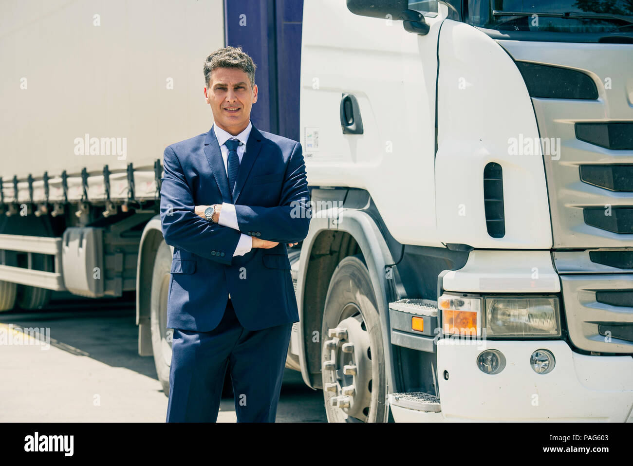 Businessman standing in front of lorry Stock Photo