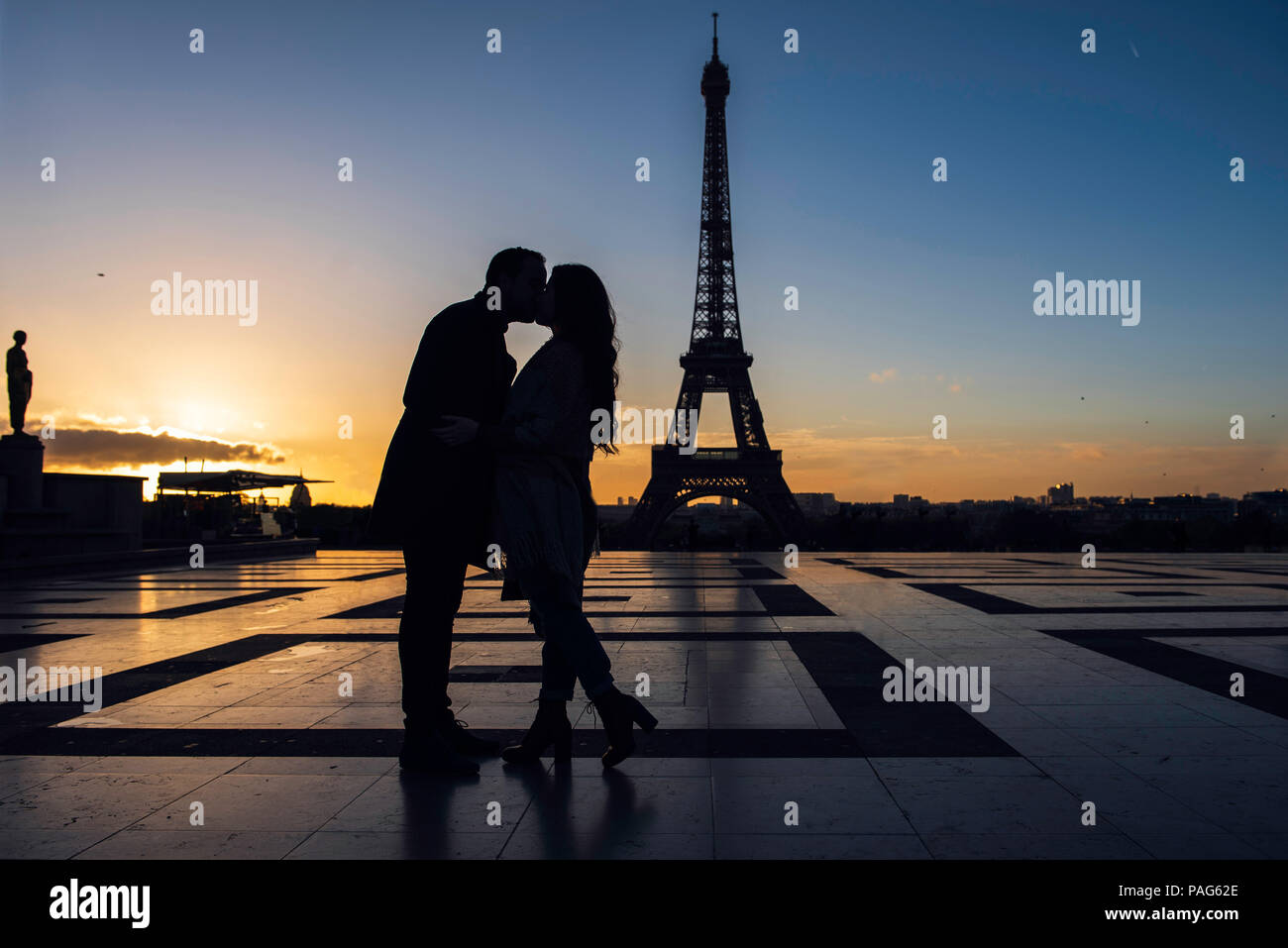 Couple kissing each other at Eiffel Tower Stock Photo