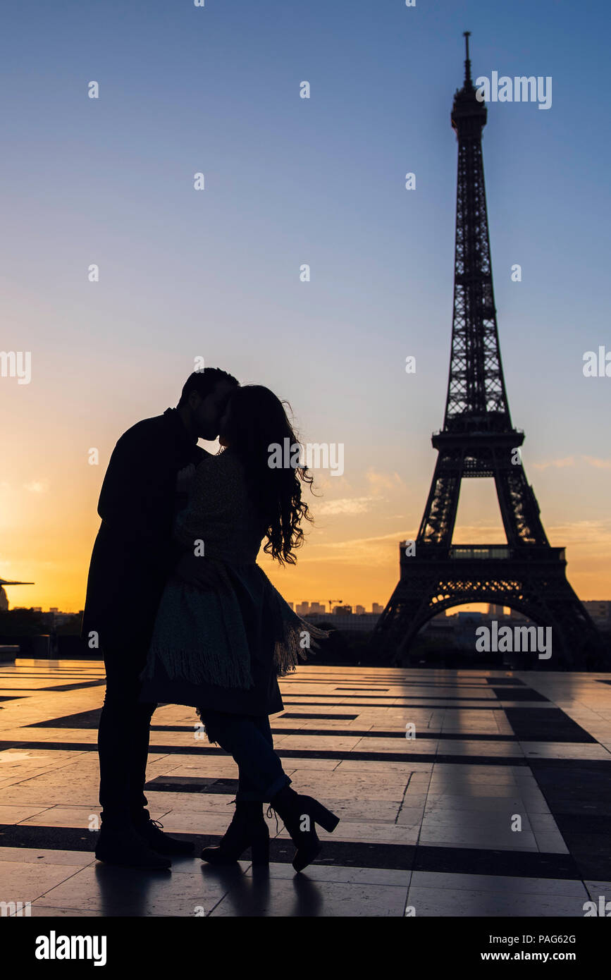 Couple kissing each other at Eiffel Tower Stock Photo