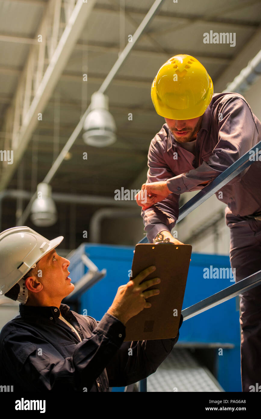 Factory workers with clipboard in factory Stock Photo