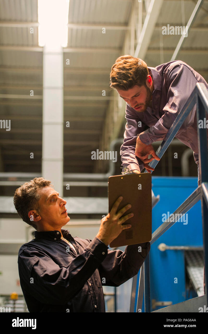 Factory workers with clipboard in factory Stock Photo