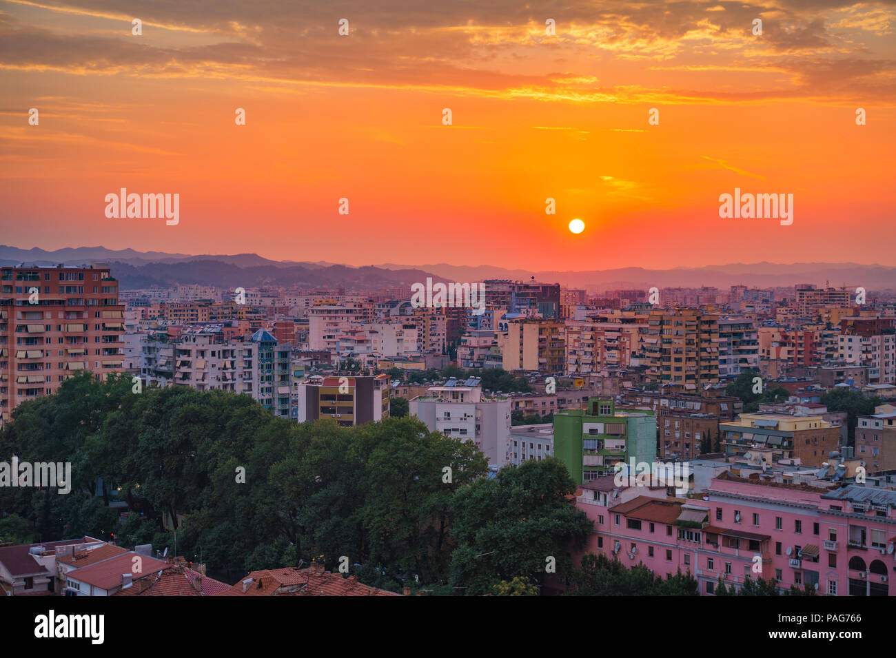 Areal cityscape view of Tirana city center at sunset. Modern Architectural buildings and urban