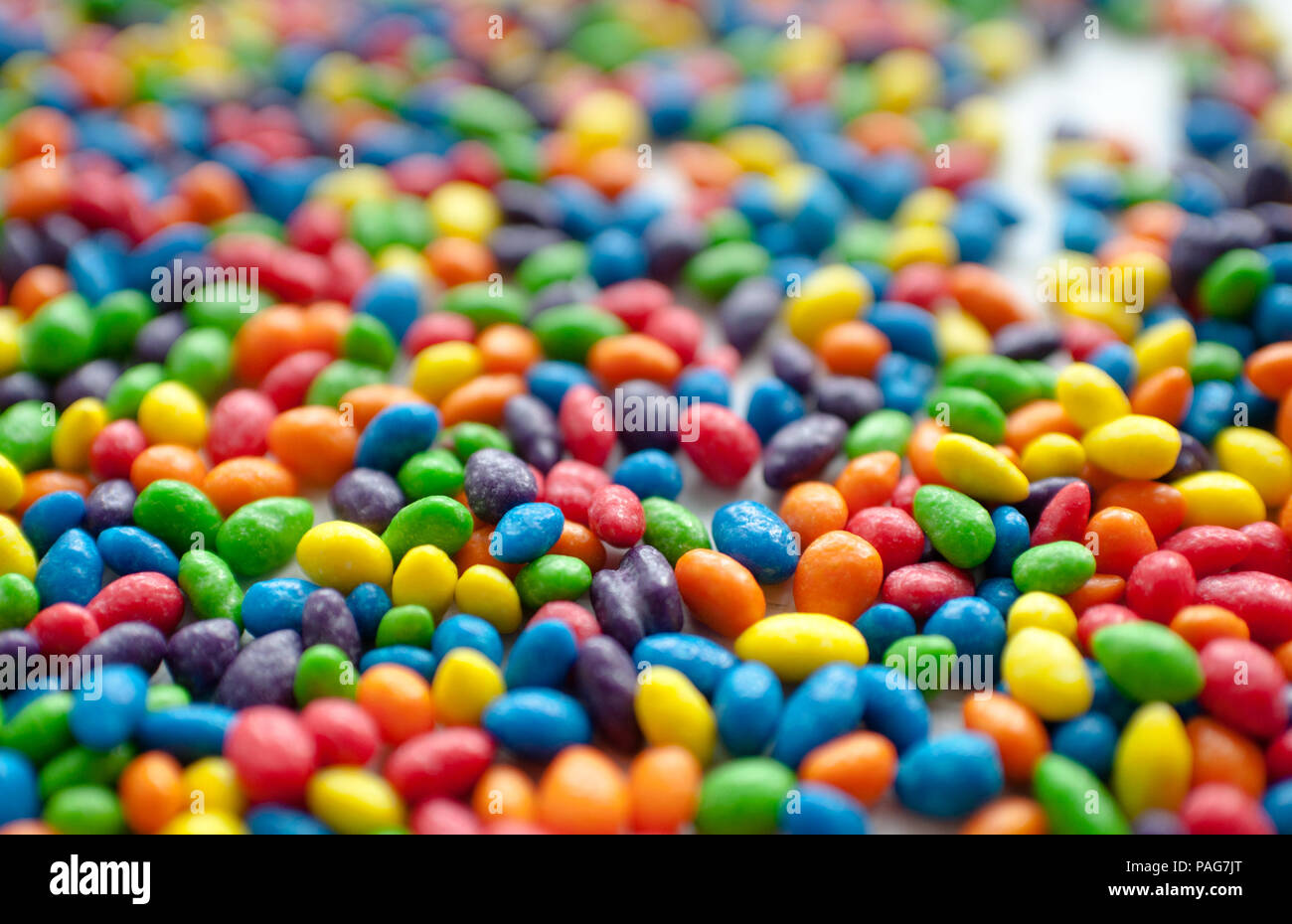 Multi-colored dragee on a white background Stock Photo - Alamy