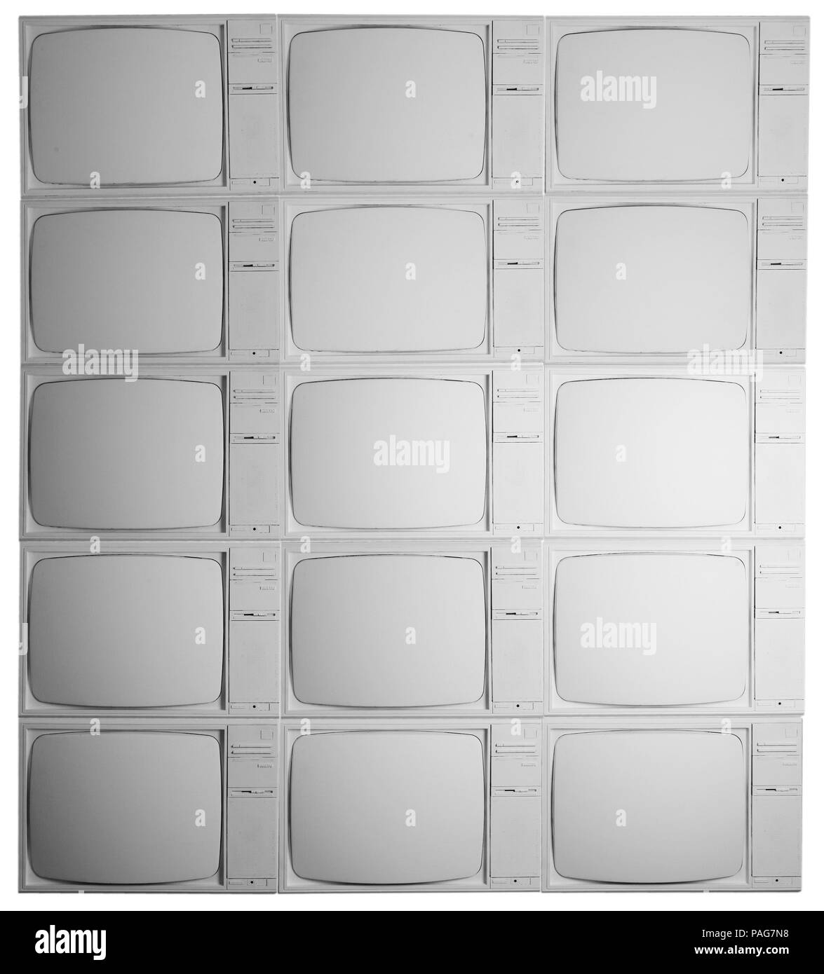 A bank of old televisions painted white. Stock Photo