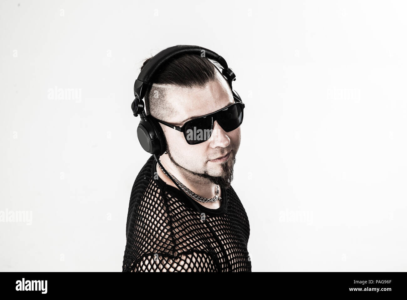 emotional and charismatic DJ rapper with headphones on a light Stock