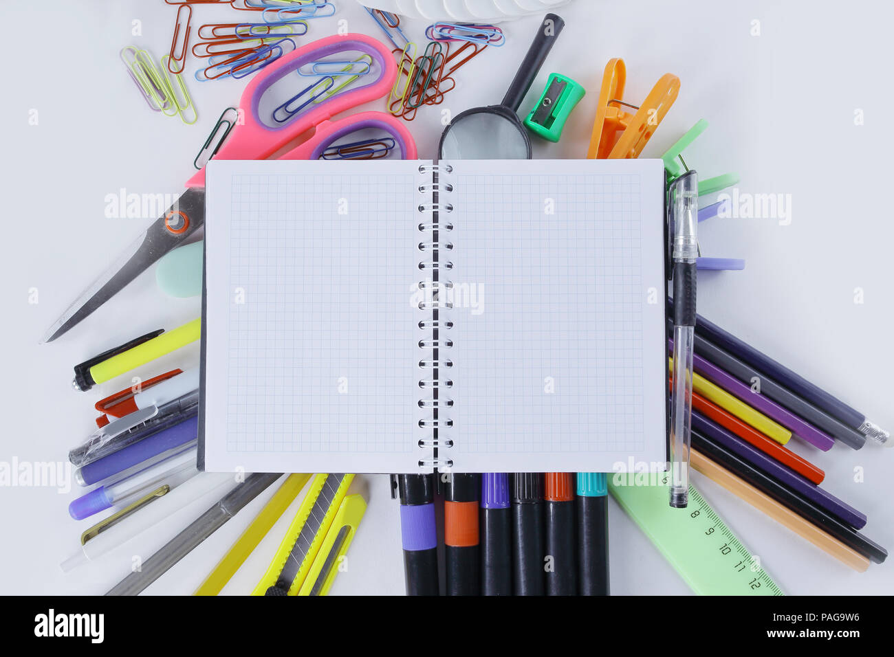 opened Notepad on office supplies on white background Stock Photo