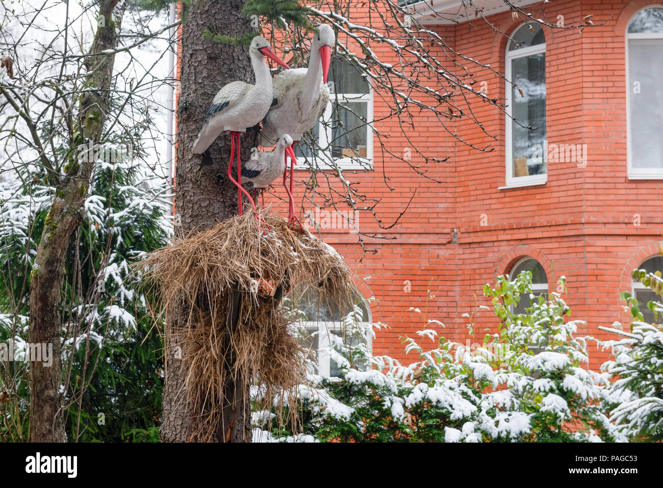 Composition with a nest of storks in front of the house. The stork symbolizes chastity, purity, respectfulness, circumspection and vigilance, therefor Stock Photo