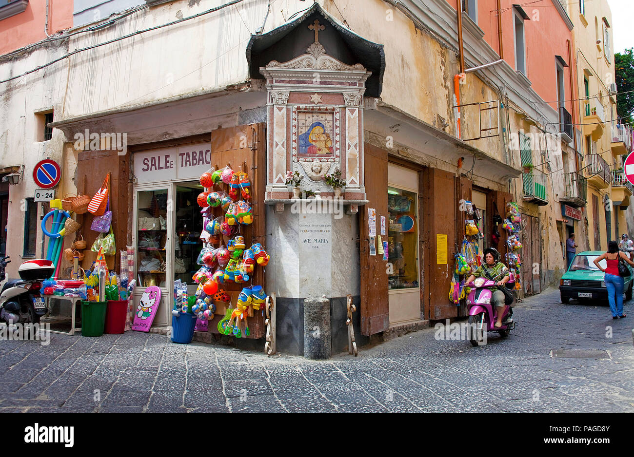 Images of Saints at a junction with souvenir shops, old town of Procida island, Gulf of Naples, Italy Stock Photo