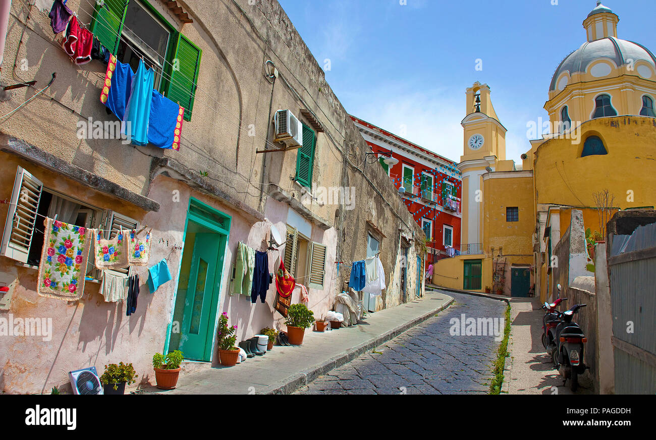 Fisherman's house with out hanging laundry and church Chiesa della Madonna delle Grazie, old town of Procida, Gulf of Naples, Italy Stock Photo