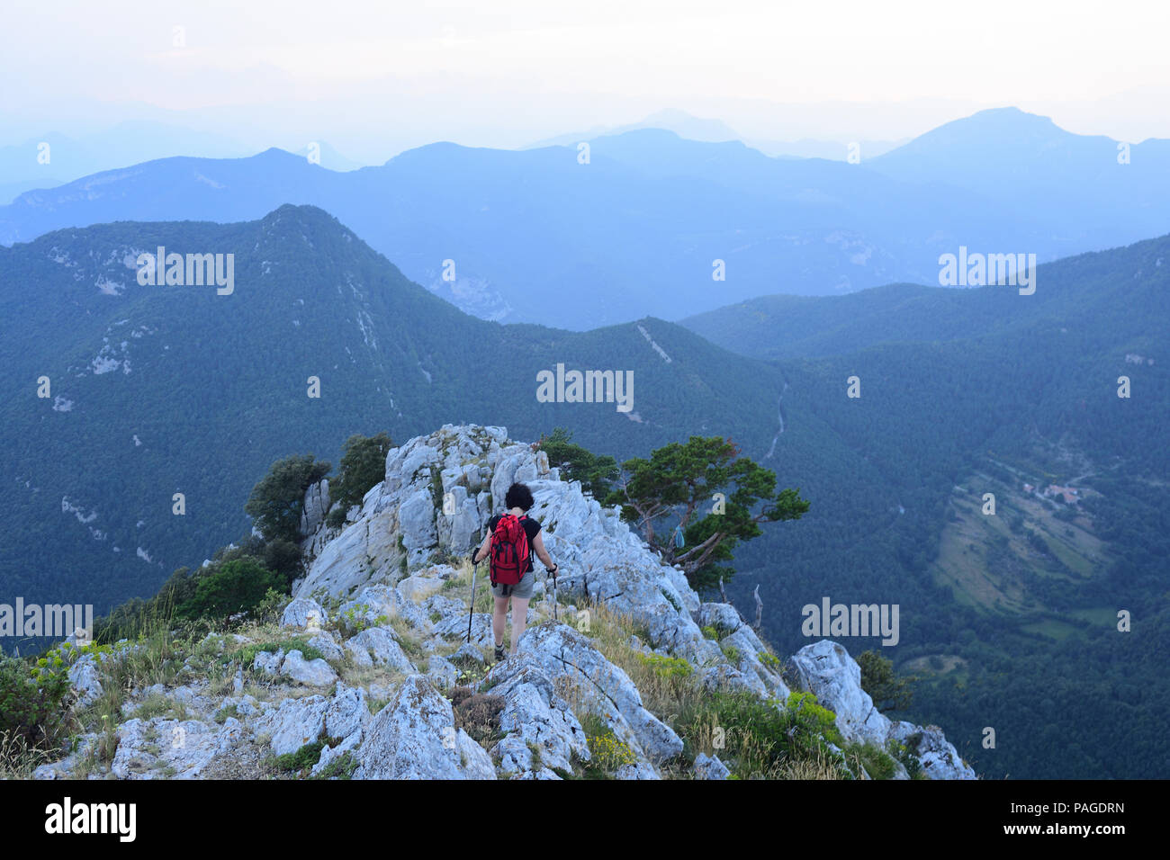 Woman on top mountain stretching hi-res stock photography and images ...