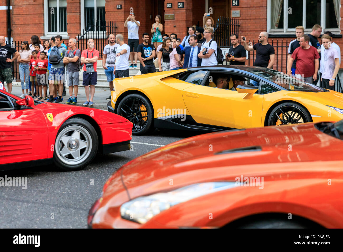 Sloane Street, London, UK, 20th July 2018. 'Supercar Tricolore' with a red  Ferrari at the centre.. Supercars, high-performance and classic cars, as  well as some characterful adaptions, line up and drive along