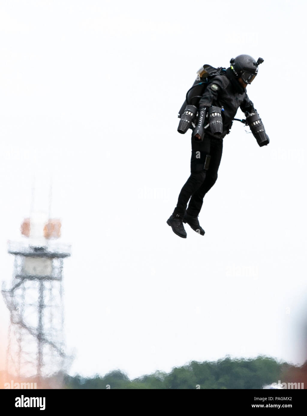 Farnborough, London. 22nd July, 2018. 'Iron Man', Richard Browning, with small jet engines mounted on each arm and behind the suit's back, performs (vertical take-off and flight) at the Farnborough International Airshow, southwest of London, Britain on July 22, 2018. Credit: Han Yan/Xinhua/Alamy Live News Stock Photo