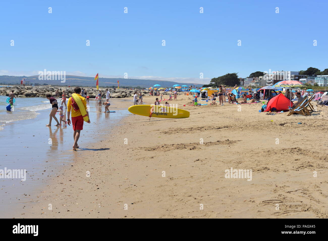 Sandbanks, Poole, Dorset, UK, 23rd July 2018, Weather: It’s hot and sunny on the beach and people are out enjoying the Mediterranean-like conditions. The glorious summer of 2018 continues in the south of England. Stock Photo
