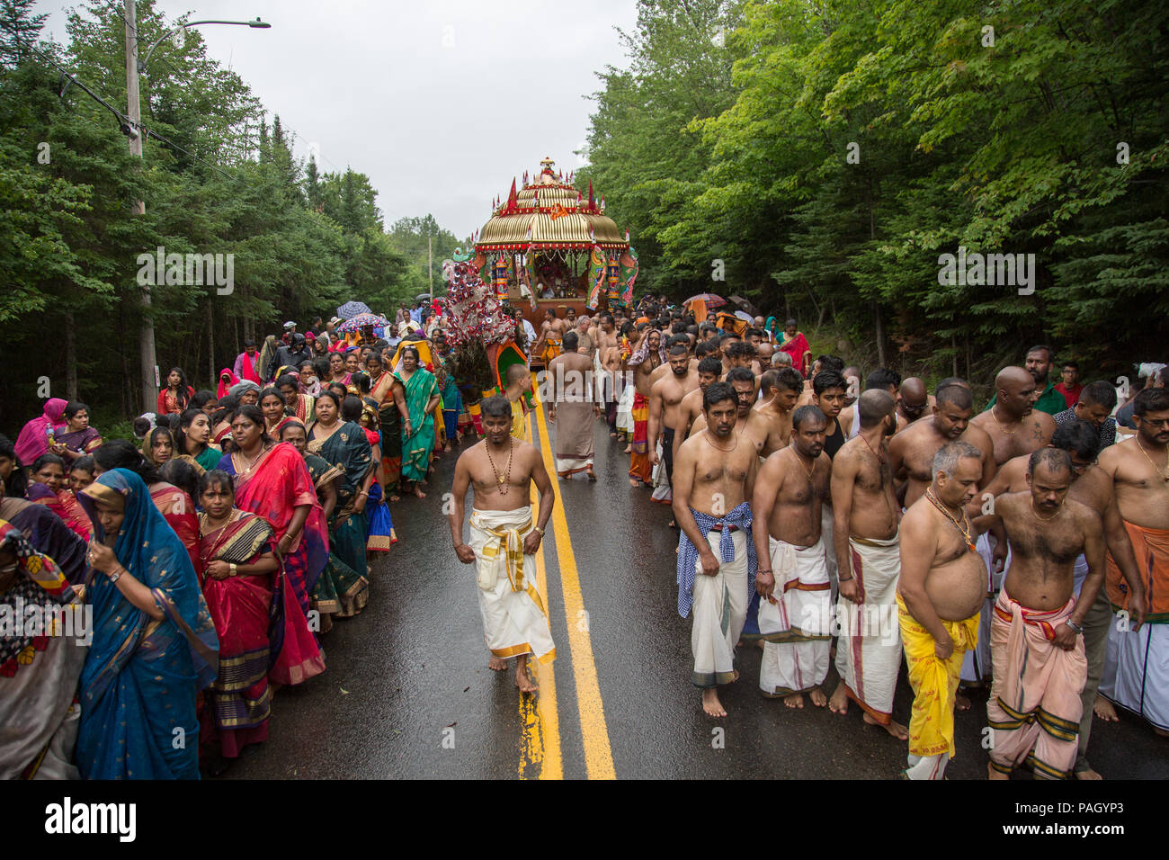 Val-Morin, Canada, July 22, 2018. Hundreds of Hindu devotees gathered in Val-Morin, Quebec, for the Kaavadi festival, an annual celebration of Lord Subramanya (or Muruga), the Hindu god of war. Several devotees are suspended by hooks and needles piercing their skin as a way o penance and transcendence. Other devotees carry kaavadis (arches adorned with peacock feathers) on their shoulders, as it is believed that they are great conductors of spiritual energy. Credit: Cristian Mijea/Alamy Live News. Stock Photo